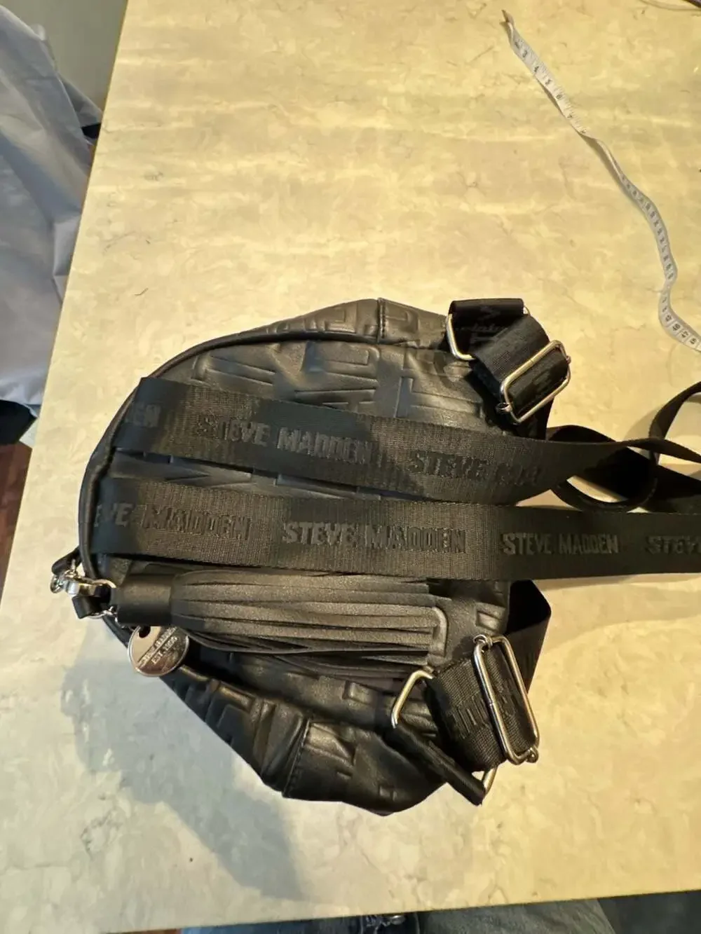 Steve Madden Black Mini Backpack Purse with Embossed Logo and Tassel